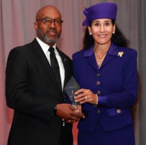 Perry Watson IV, President of the National Association of Minority Automobile Dealers (NAMAD), presents Rita Case, president and CEO of Rick Case Automotive Group, with the organization’s Lifetime Achievement Award. (Photo credit: Andrea Stinson/Stinson Photography LLC)